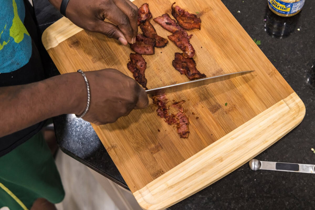 chopping bacon on a cutting board