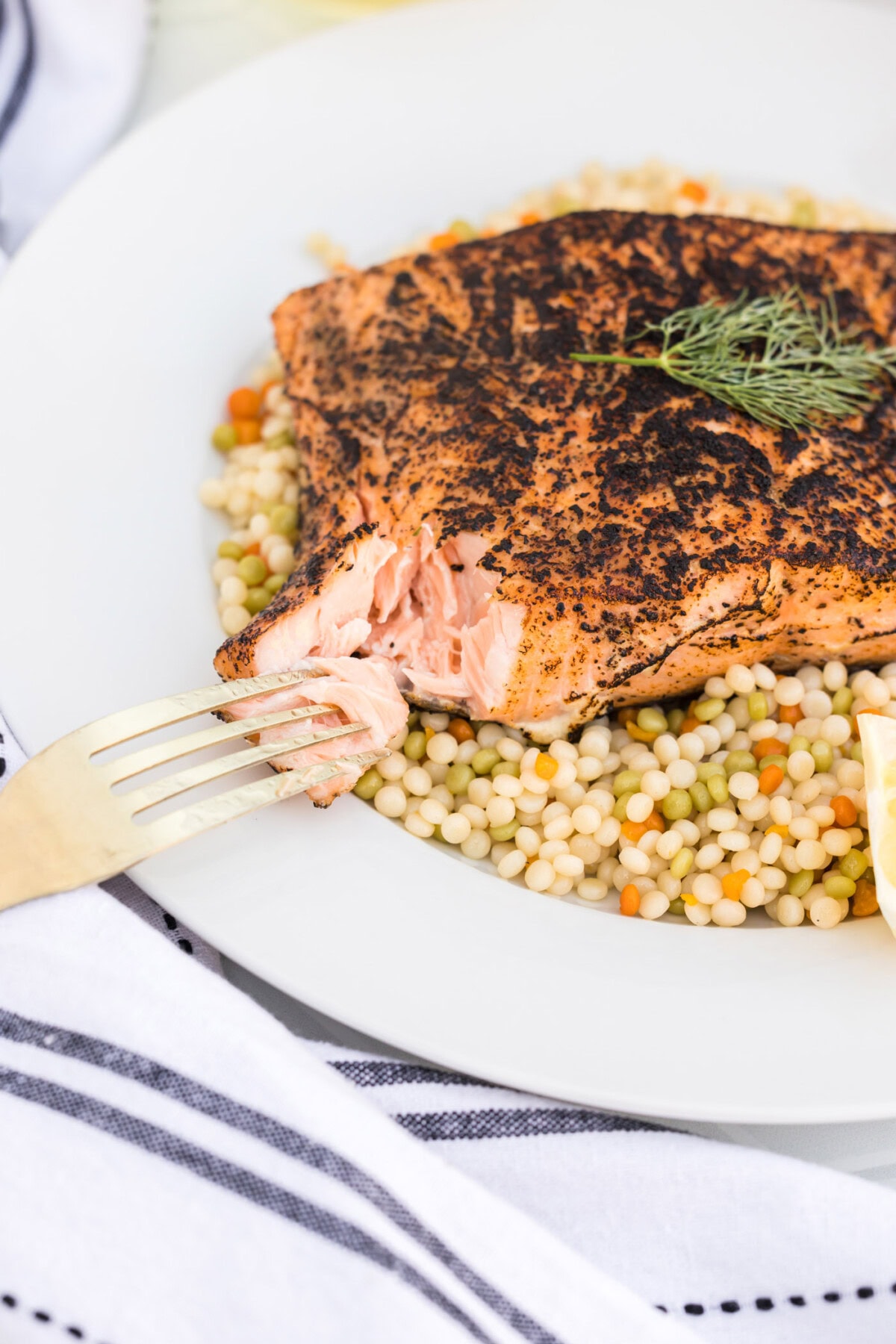 Sous Vide Salmon on a plate with a piece of salmon taken off and on a fork