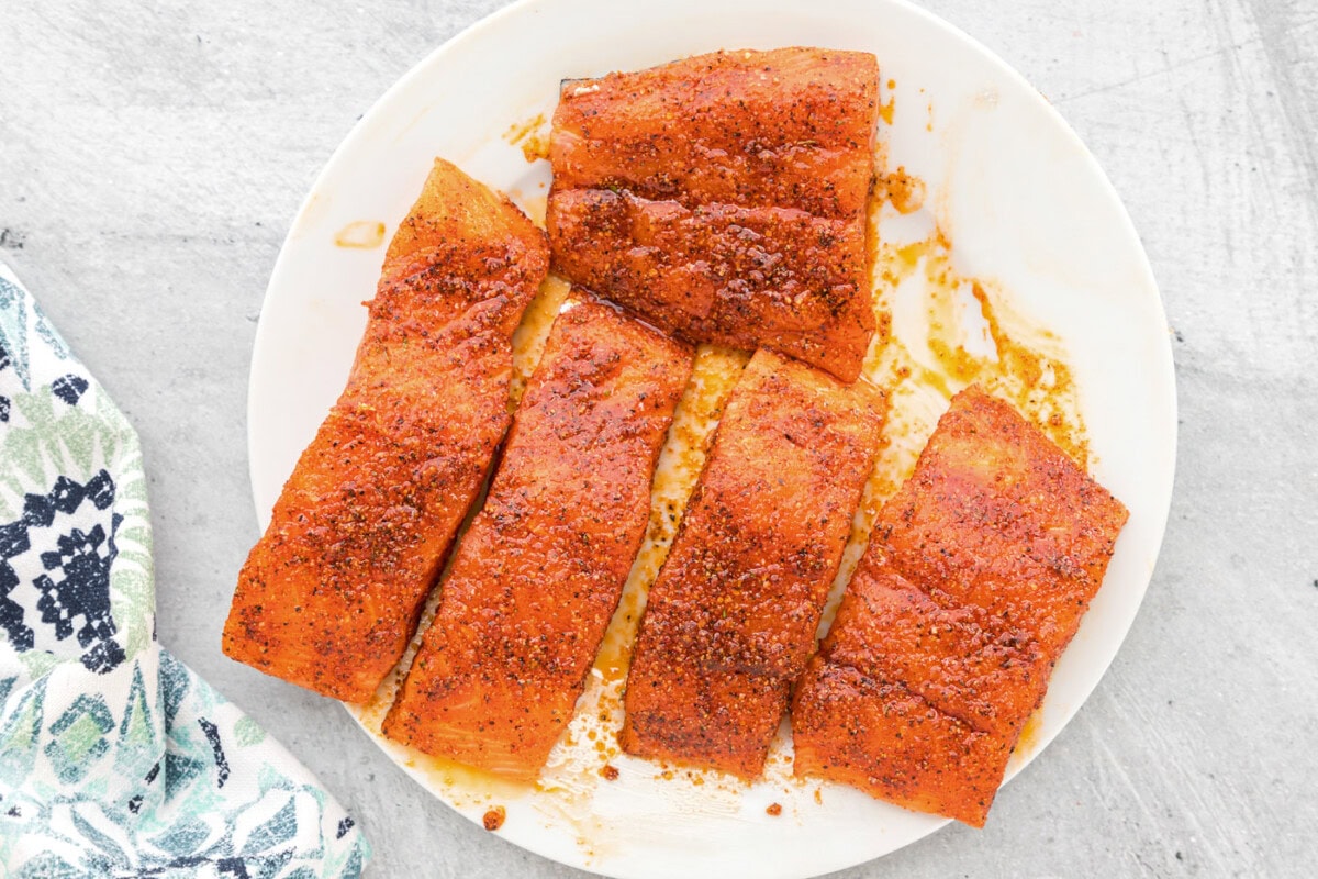 salmon filets coated in seasonings on a plate