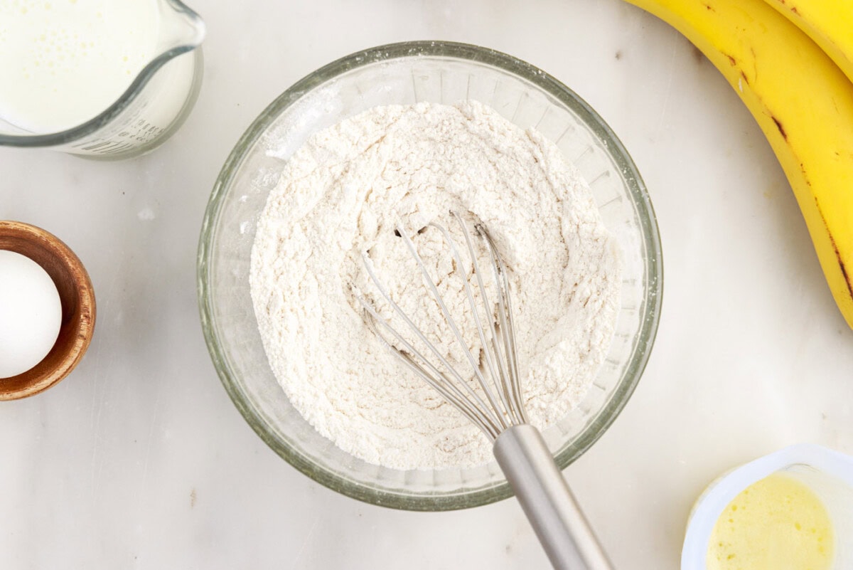 whisking together the flour, sugar, baking soda, baking powder, salt, and cinnamon 