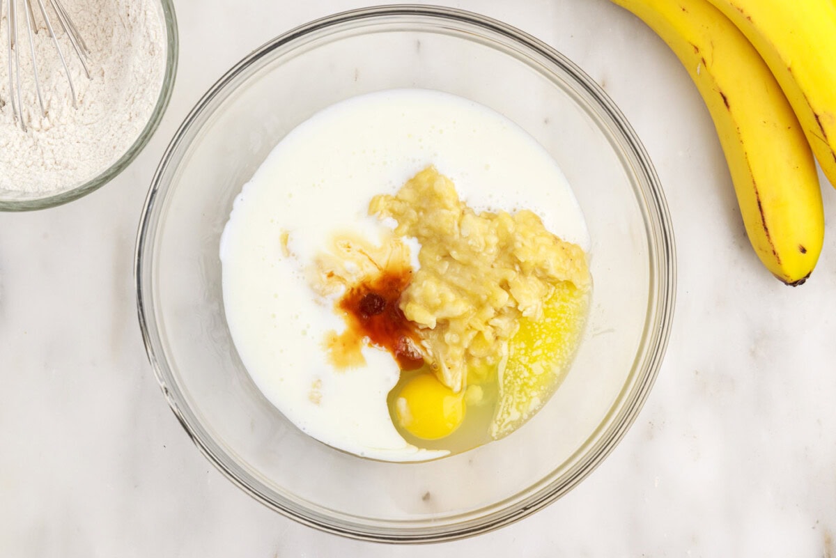 wet ingredients for banana pancake batter in a bowl
