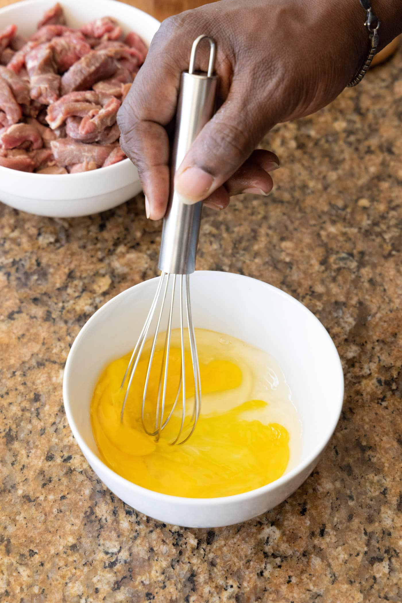 whisking egg in a bowl