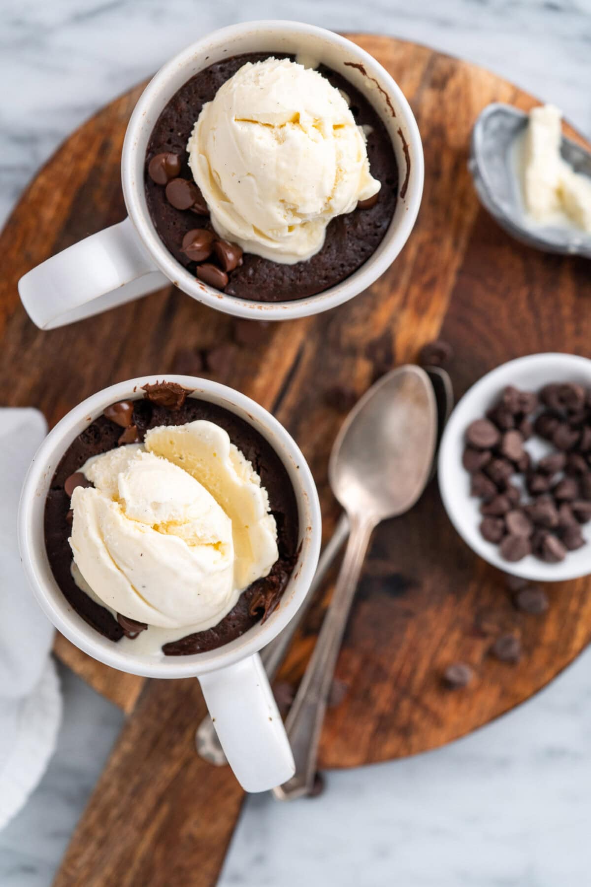 Two servings of Brownie in a Mug with ice cream on top