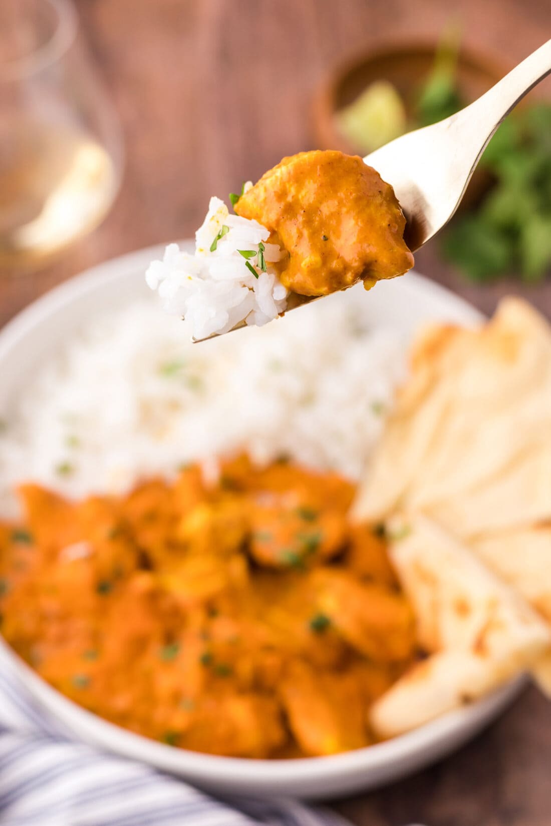 Piece of Chicken Tikka Masala on a fork with rice