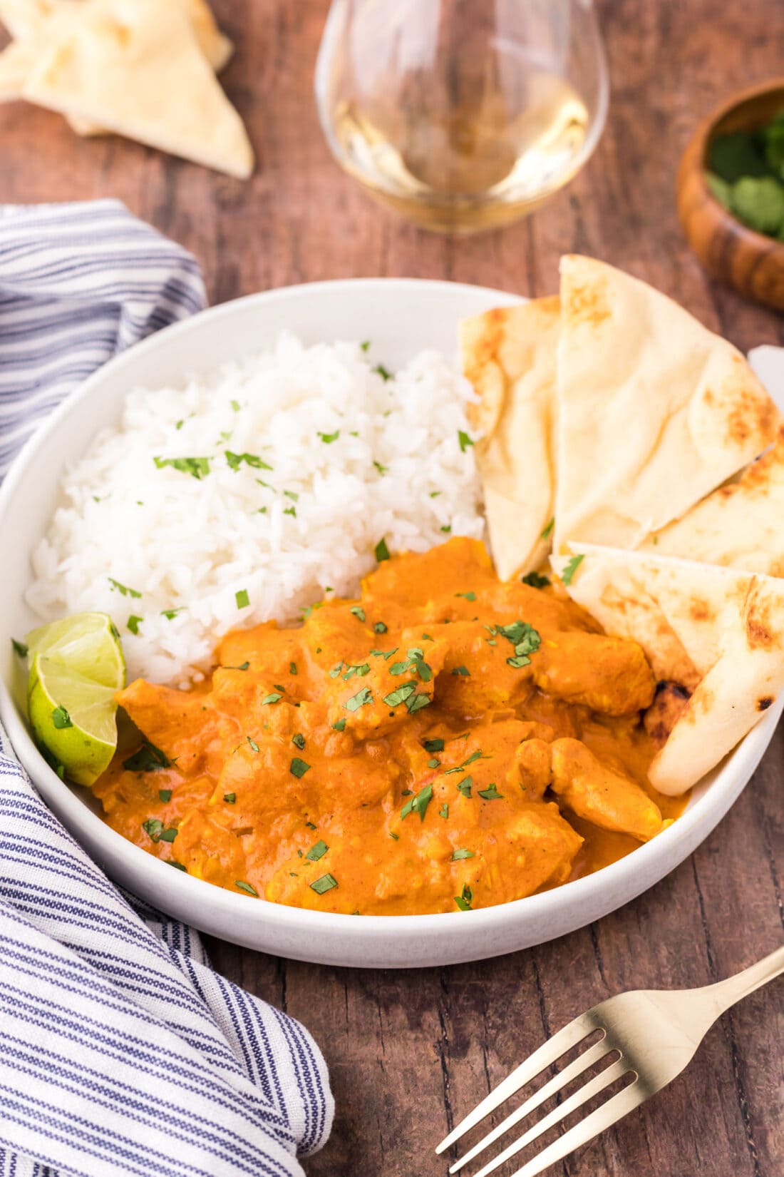 Bowl of Chicken Tikka Masala with rice and naan bread