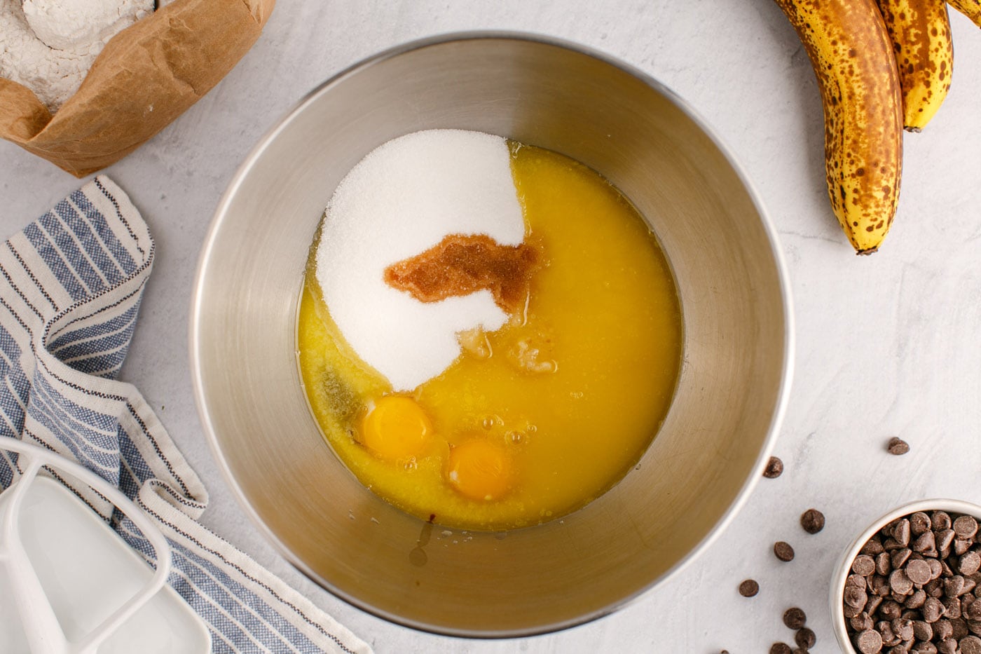 mashed bananas, eggs, vanilla, and sugar in a stand mixer bowl