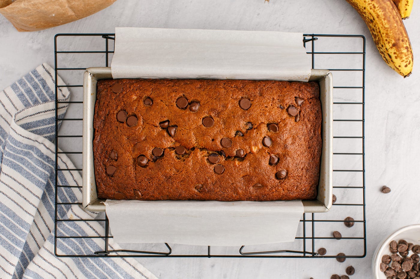 baked chocolate chip banana bread on a wire cooling rack