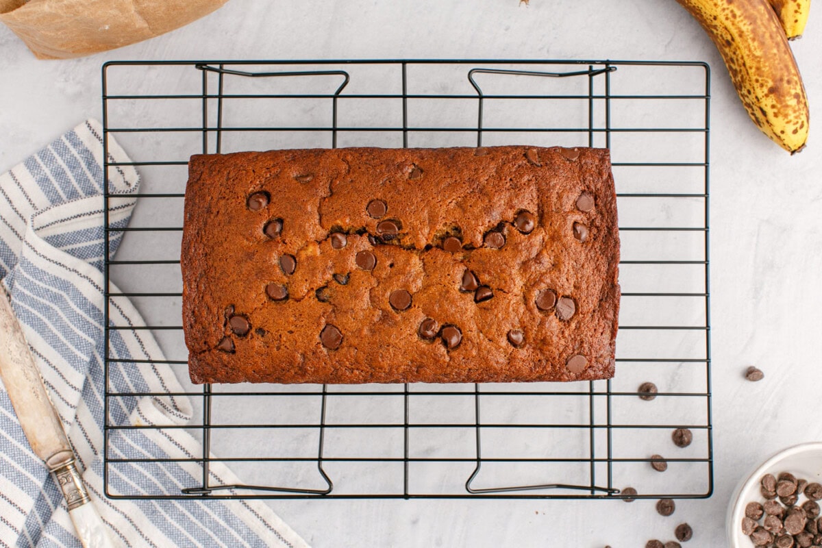 banana bread with chocolate chips on a wire cooling rack