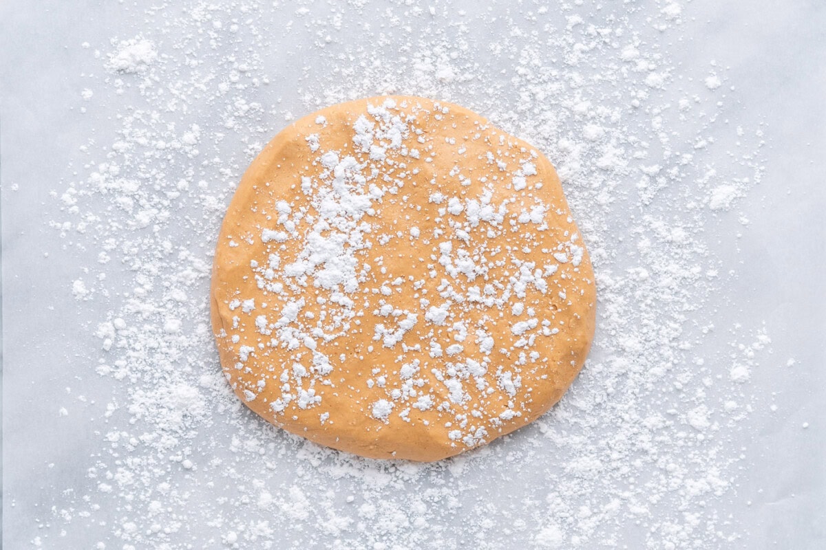 peanut butter dough laid flat with powdered sugar sprinkled on top