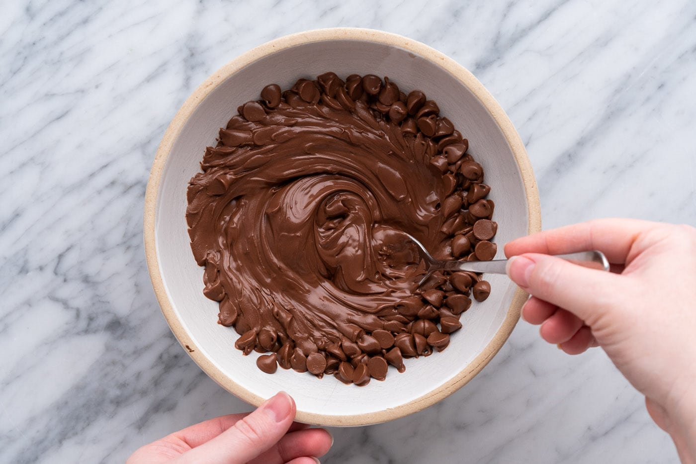 stirring melted chocolate chips in a bowl