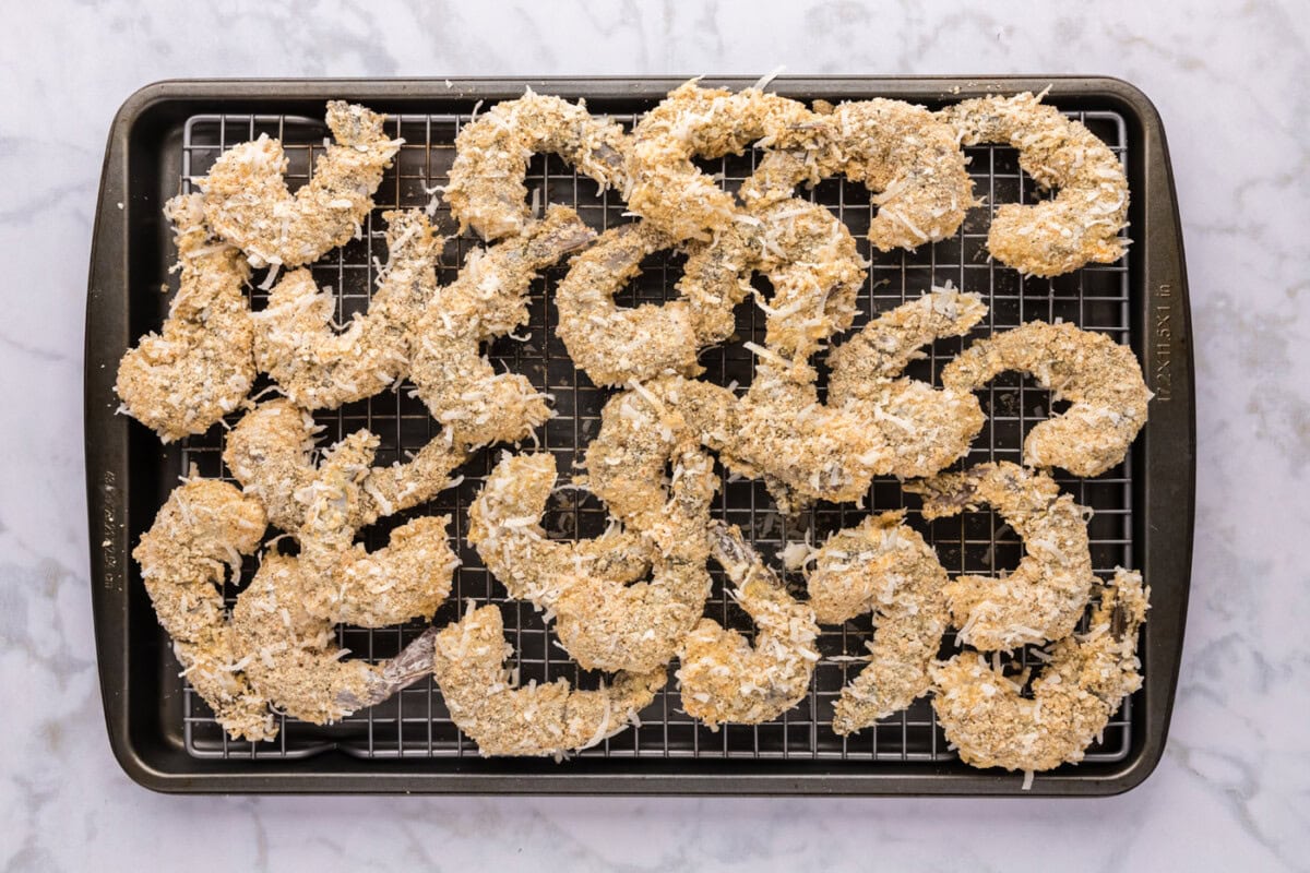 coconut panko coated shrimp on a baking sheet