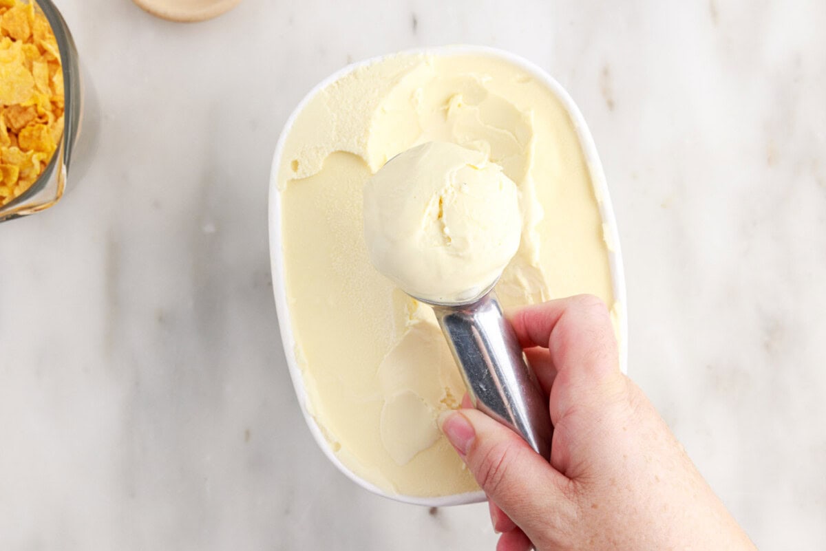 hand rolling ice cream with a scoop
