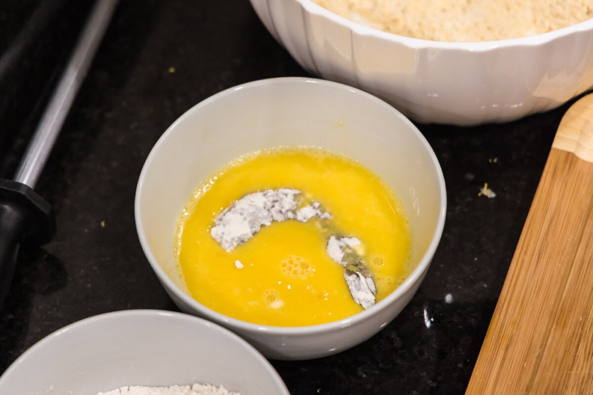 dredging floured shrimp in egg