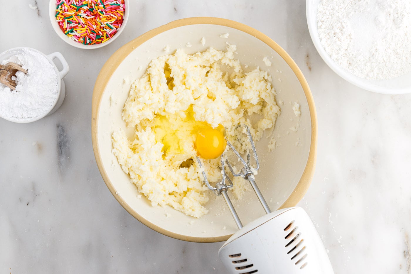 beating egg into butter and sugar mixture