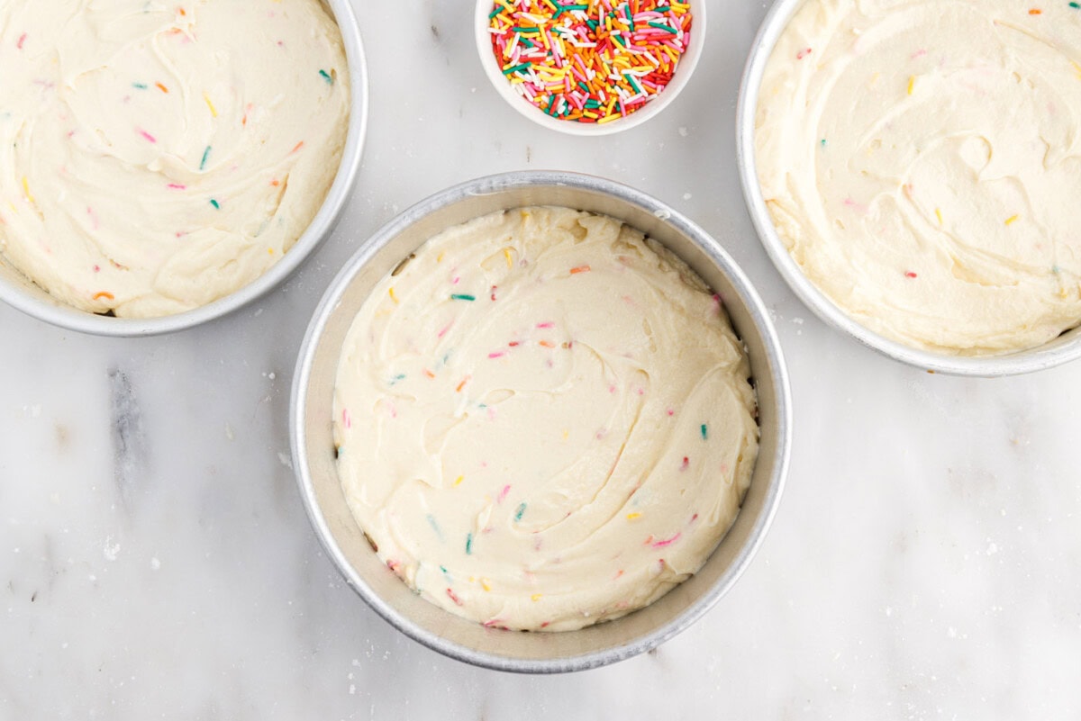 funfetti cake batter in cake pans