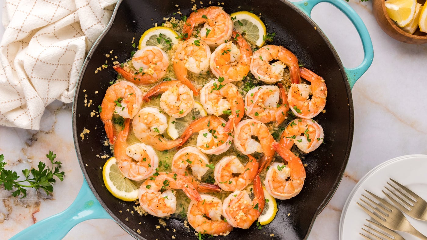 Pan-sear your lemon garlic butter shrimp in a skillet until opaque with pops of pink and orange hues