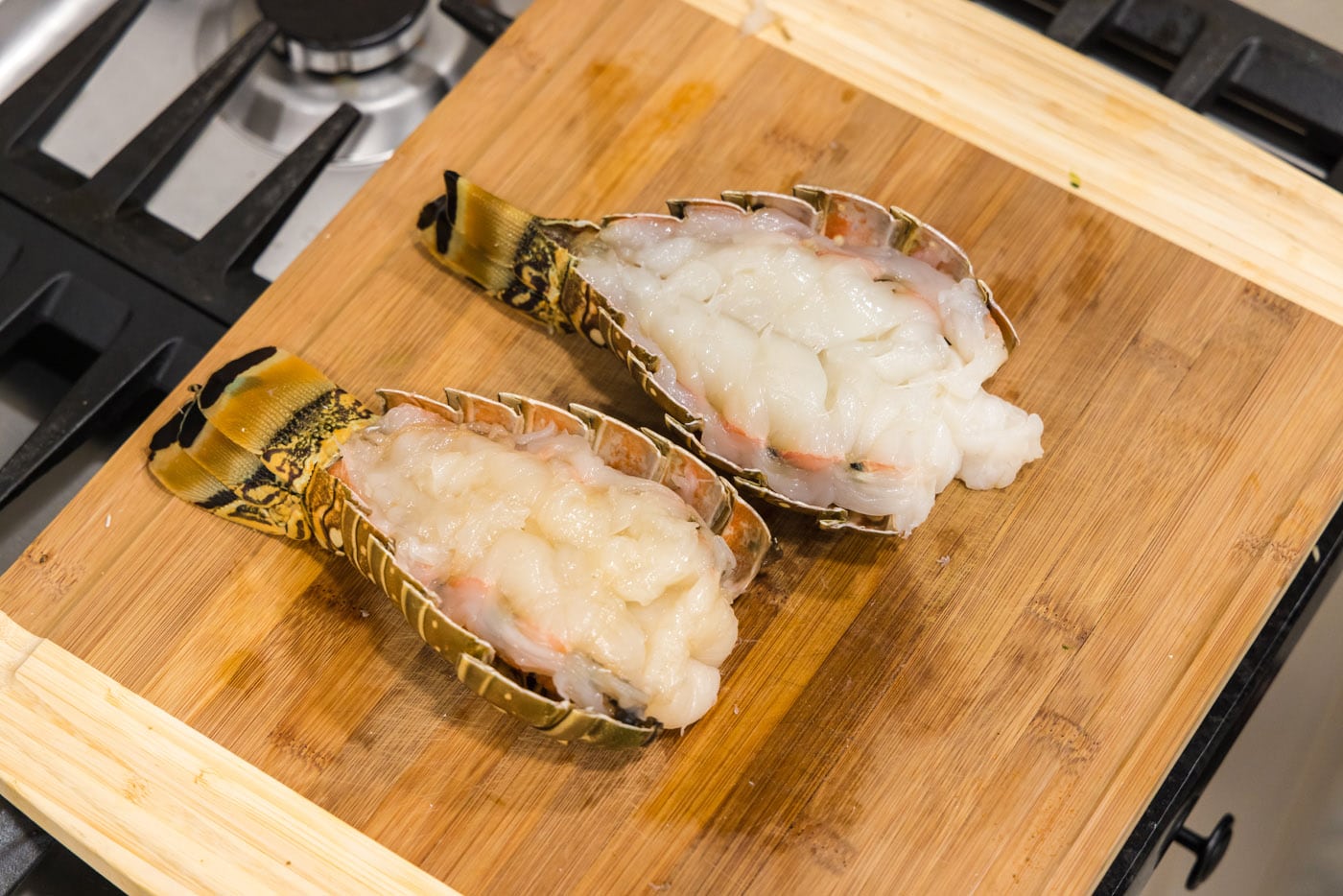 butterflied lobster tail on a cutting board