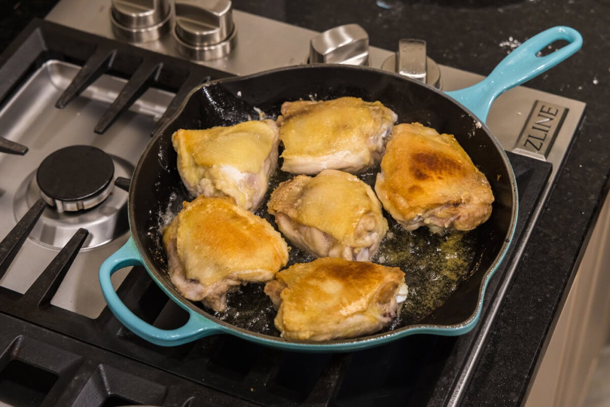 cooking chicken thighs in a skillet