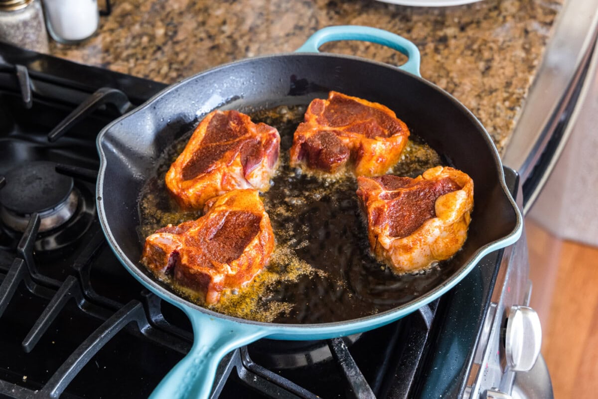 searing lamb chops in a skillet