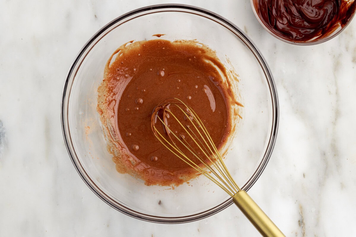 whisked chocolate with egg yolks in a bowl