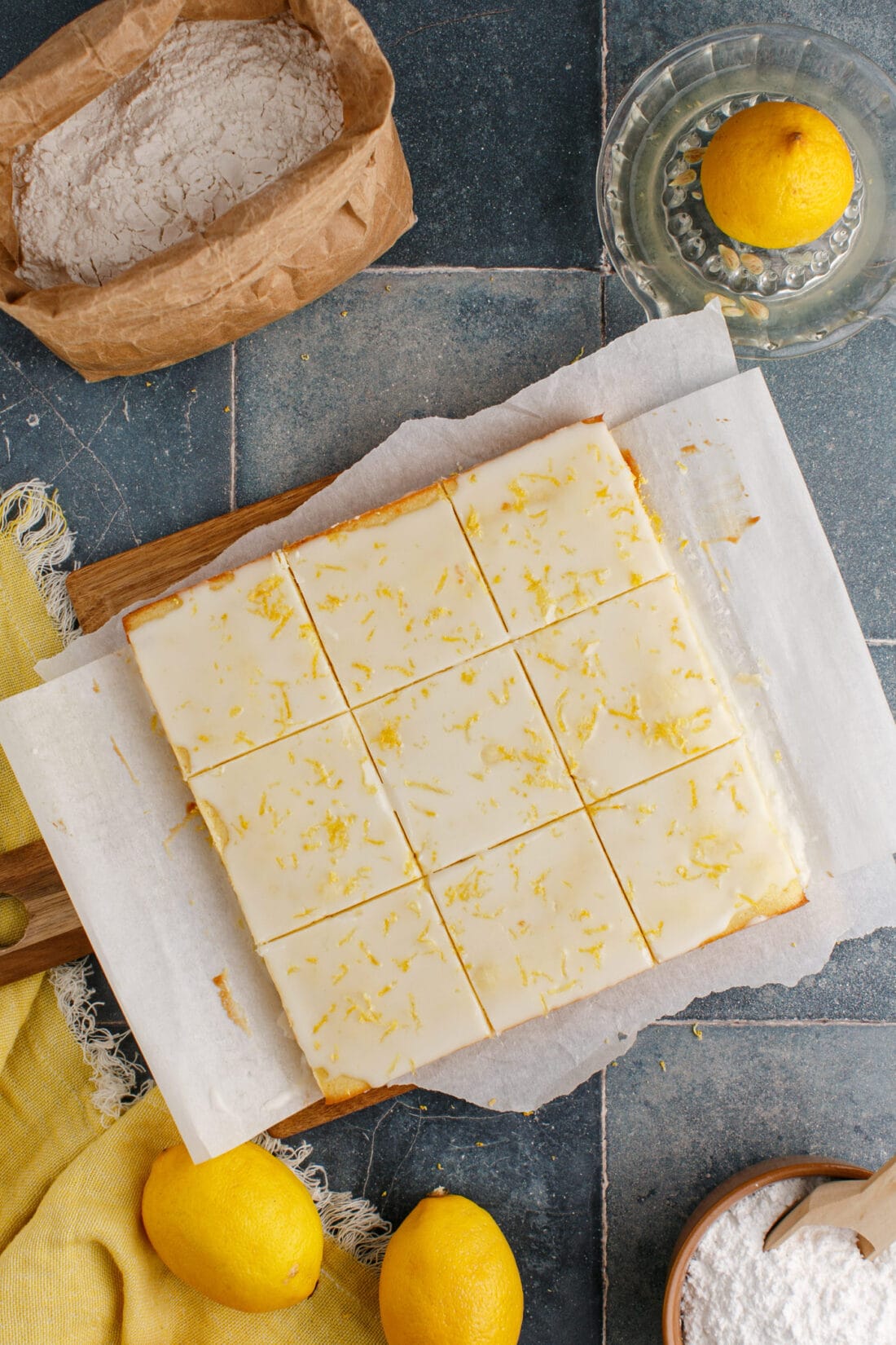 Lemon Brownies cut into squares on a wooden cutting board