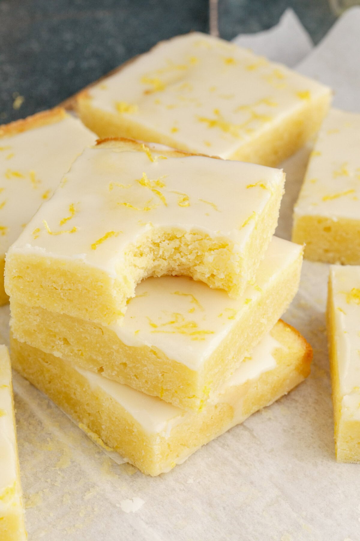 Stack of Lemon Brownies with a bite taken out of the top brownie