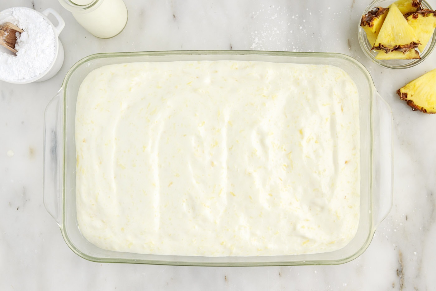 pineapple angel food cake batter in a 9x13 baking dish