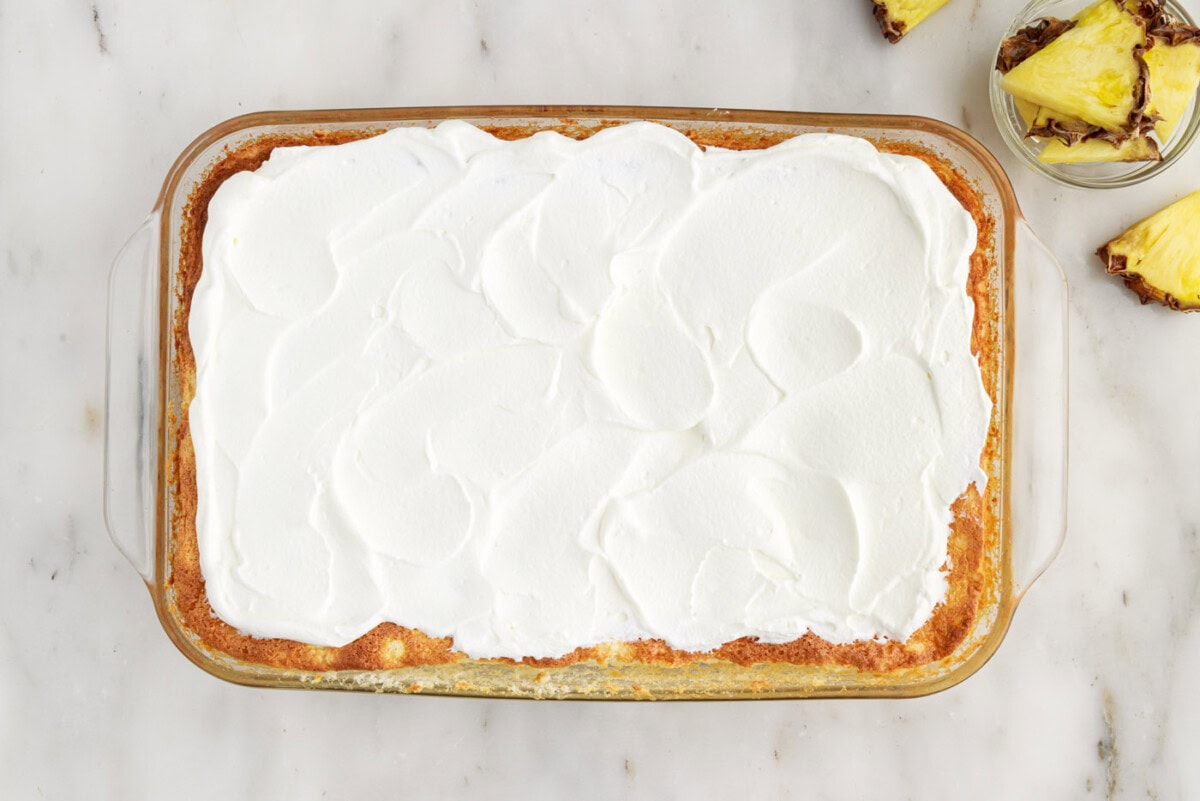 whipped cream on top of pineapple angel food cake
