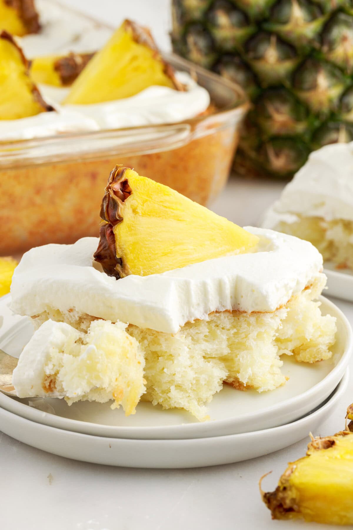 Square of Pineapple Angel Food Cake with a fork on the side