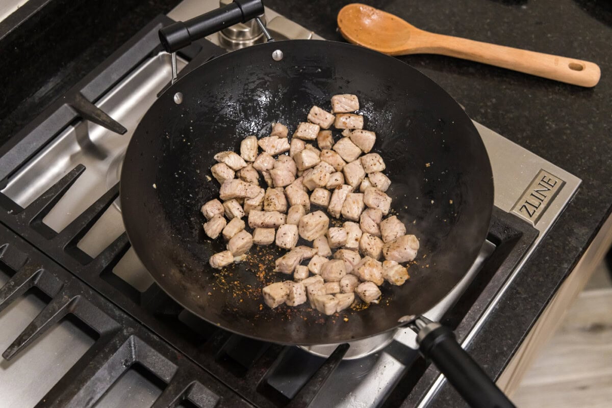 cooked diced pork chops in a wok