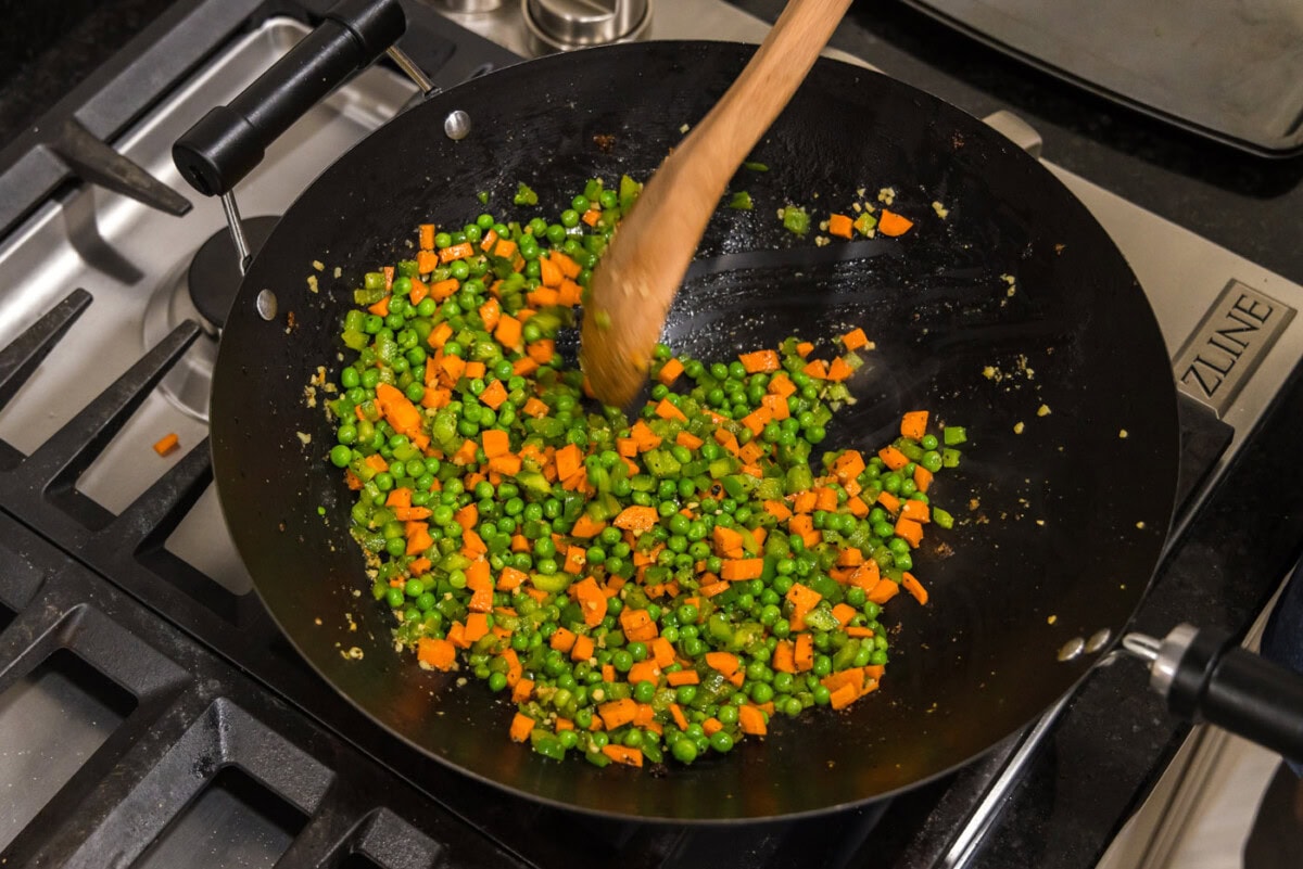 stirring vegetables in a wok