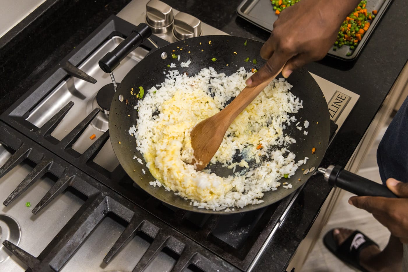 mixing white rice with egg in a skillet