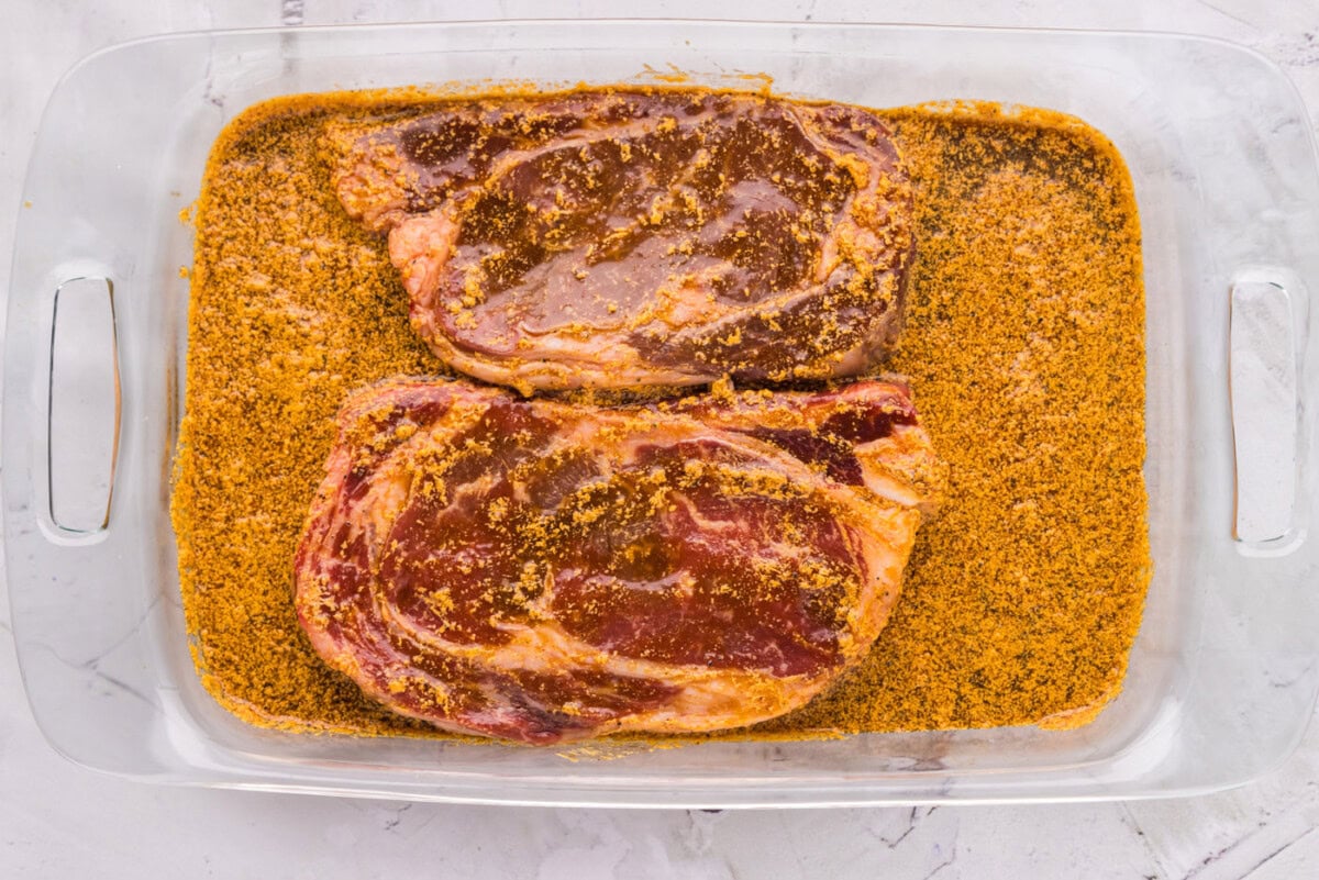 ribeye steak soaking in marinade mixture
