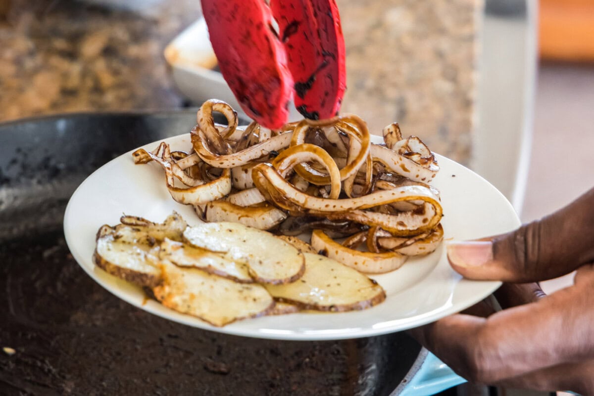 glazed onions and sliced potatoes on a plate