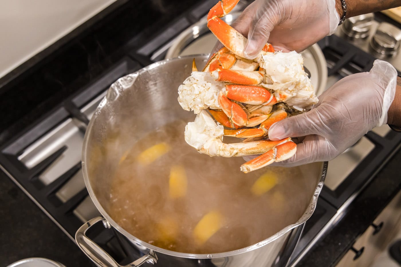 adding dungeness crab legs to seafood boil