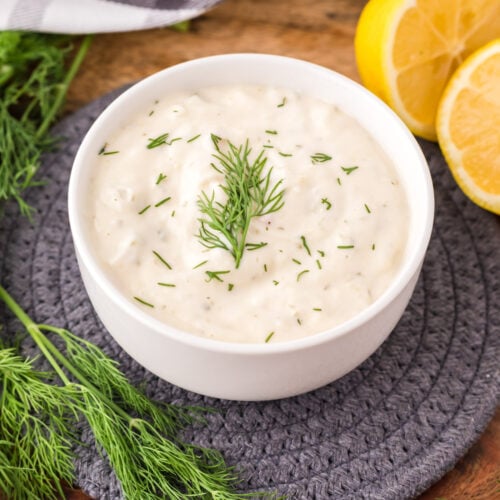 Bowl of Tartar Sauce with lemons off to the side