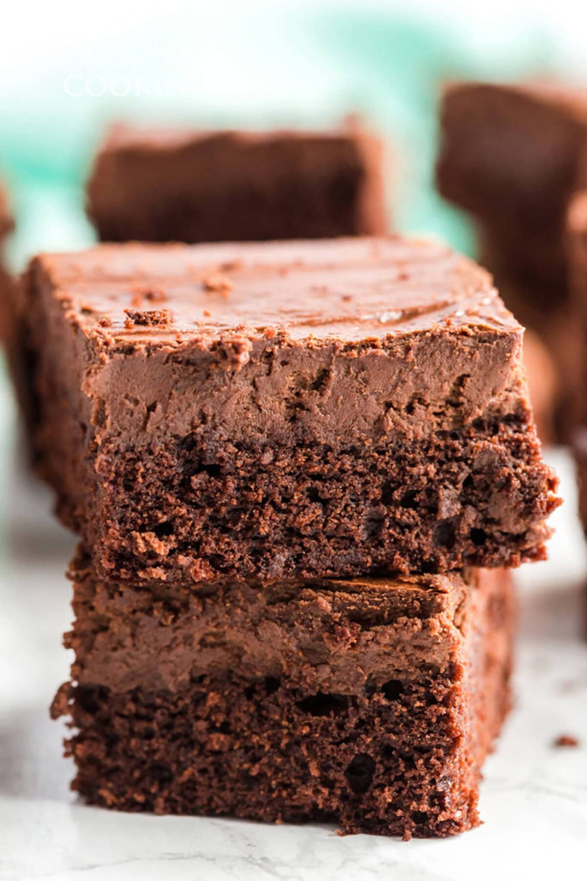 Two Chocolate Cheesecake Brownies stacked on top of each other