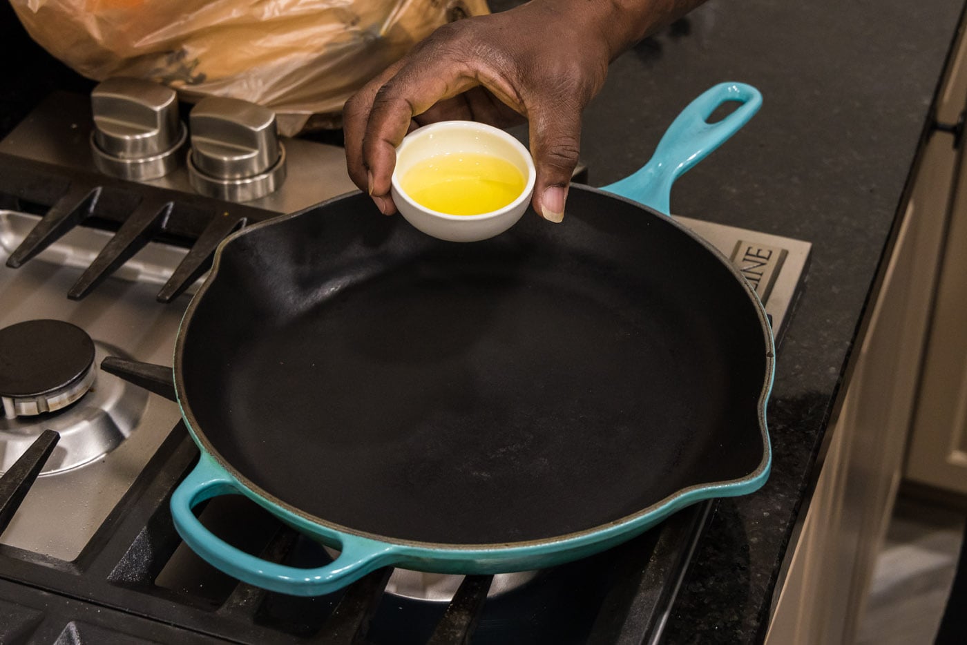 adding oil to a hot skillet