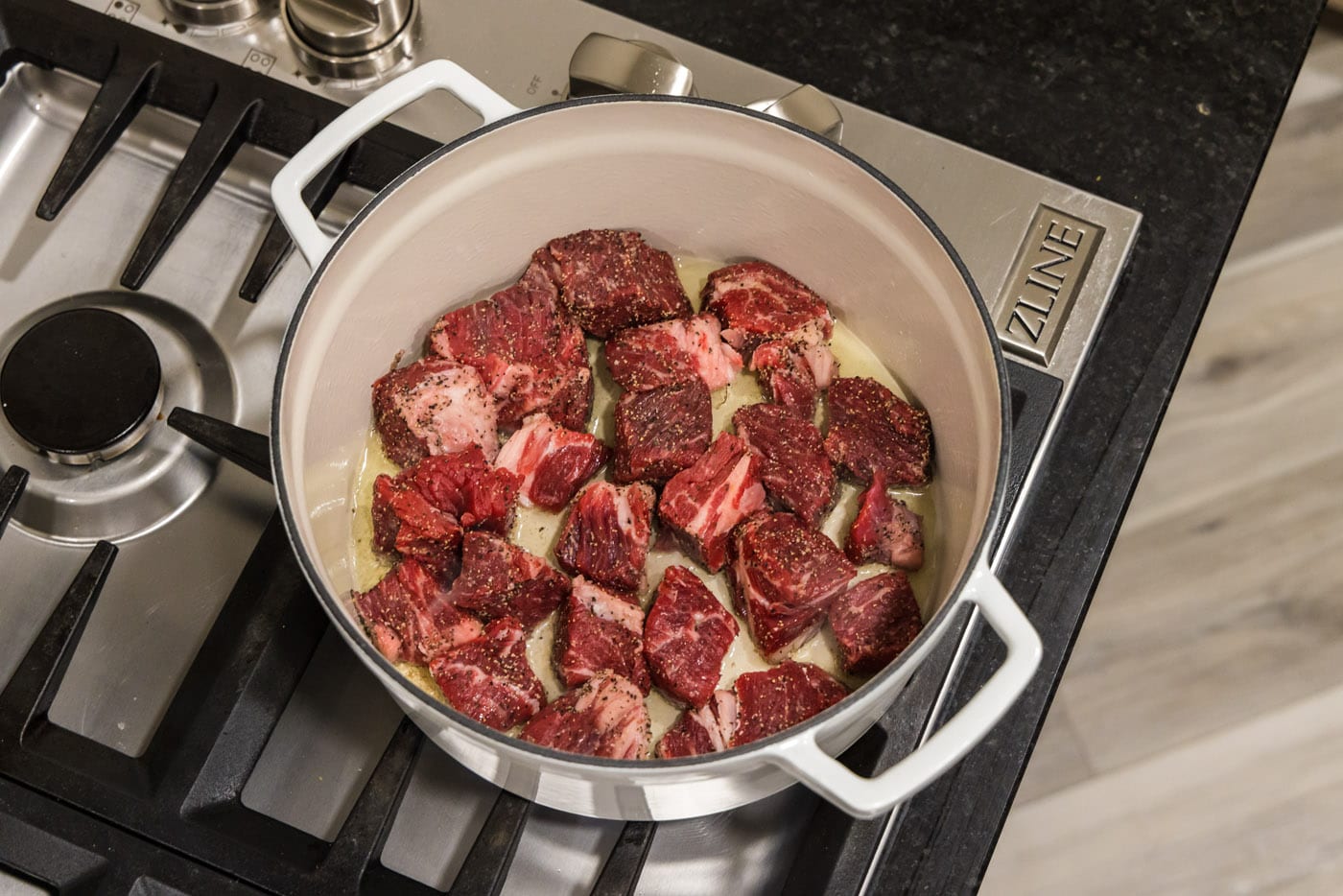 chuck roast cubes in a dutch oven with oil