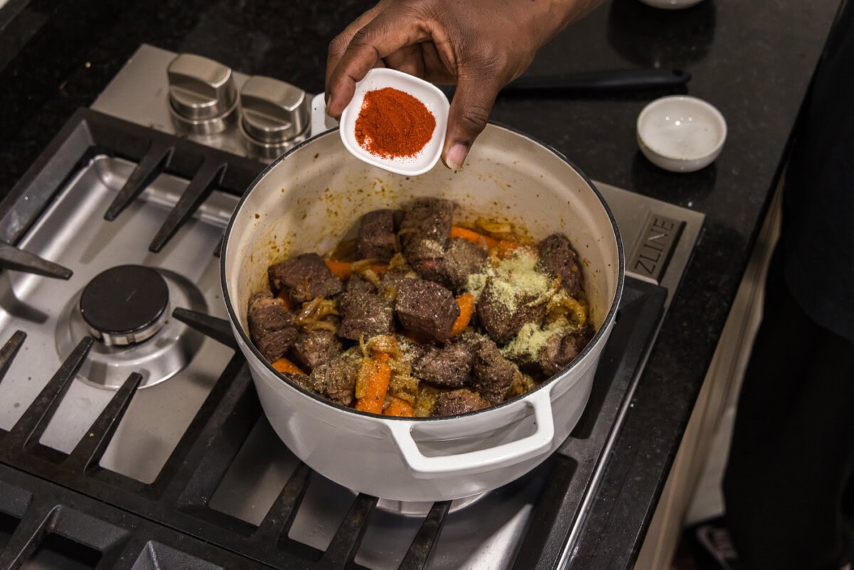 sprinkling paprika on braised beef