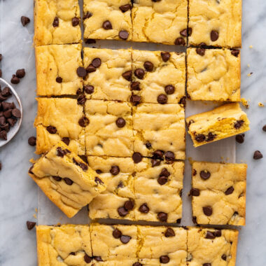 Cake Mix Cookie Bars on parchment paper with chocolate chips
