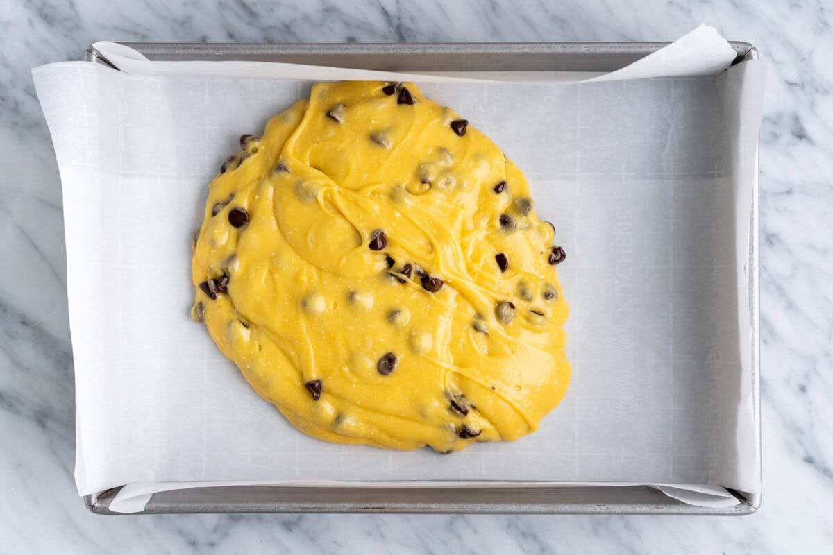 cake mix cookie bars batter poured into a baking dish