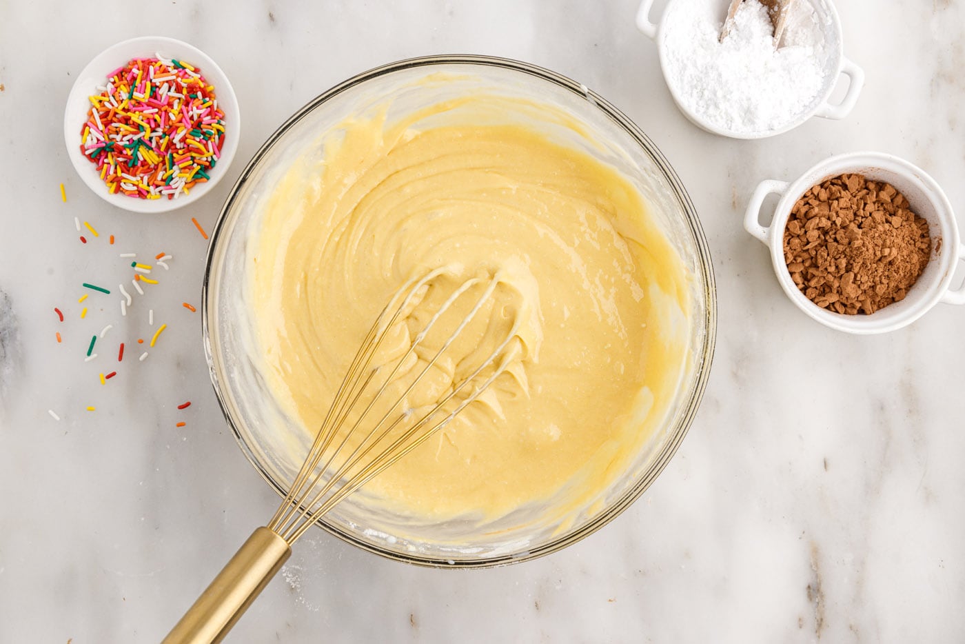 whisking together cake mix with eggs, milk, oil, and sour cream