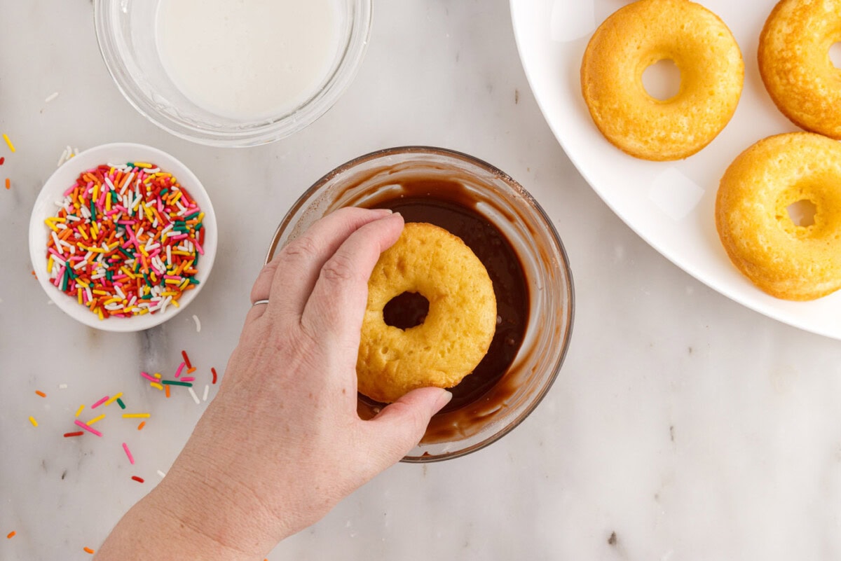 dipping donuts in chocolate glaze