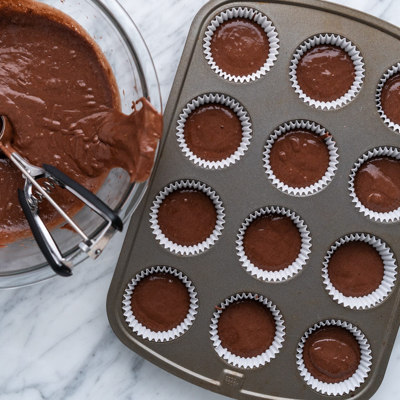 chocolate cupcake batter in a muffin pan