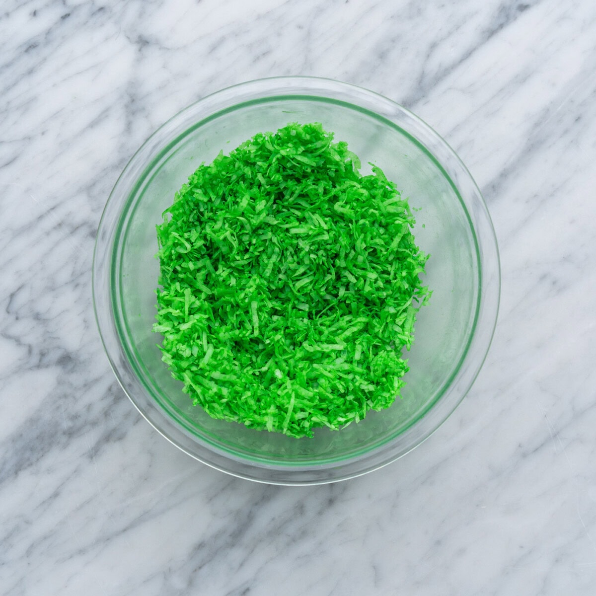 green tinted shredded coconut in a bowl