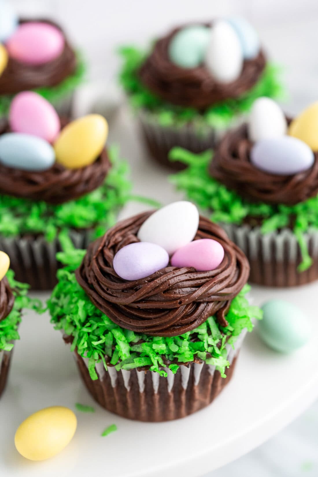 Close up photo of a Easter Nest Cupcake with more behind it