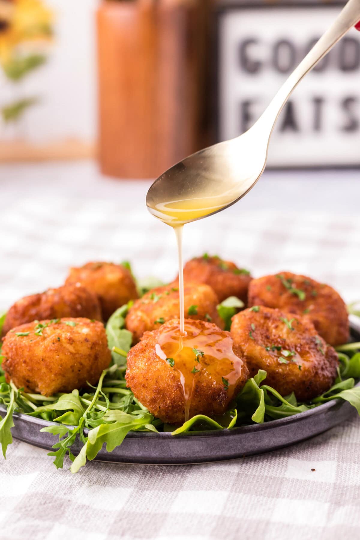 Butter being drizzled from a spoon over Fried Scallops