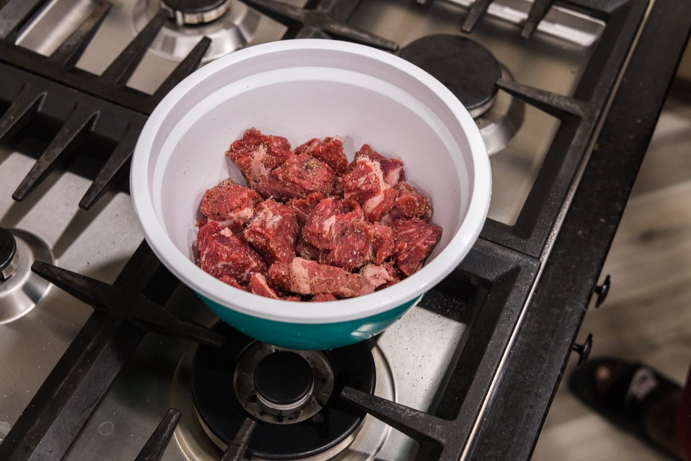 seasoned beef chunks in a mixing bowl