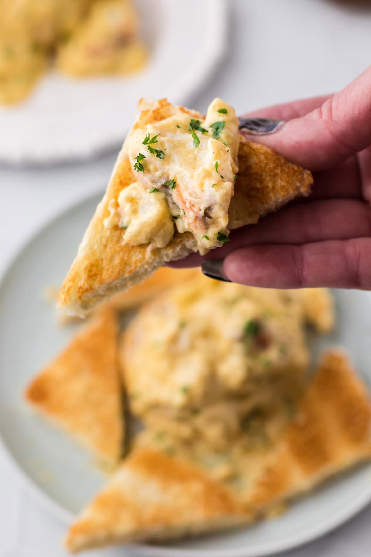 Lobster Newburg on a piece of toast